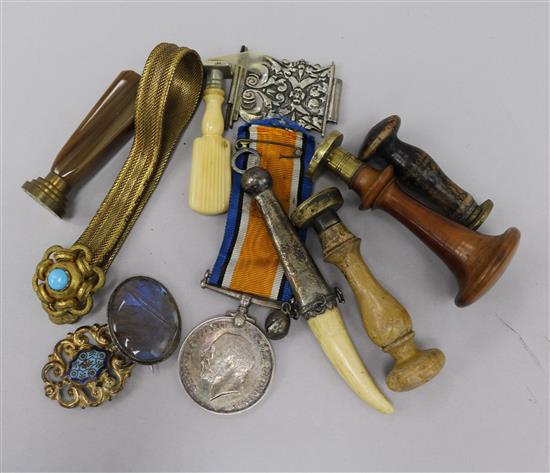 5 sealing stamps T; BE; T; BW and TI, bone dagger ornament, two buckles, brooch, bracelet and a WWI GV medal